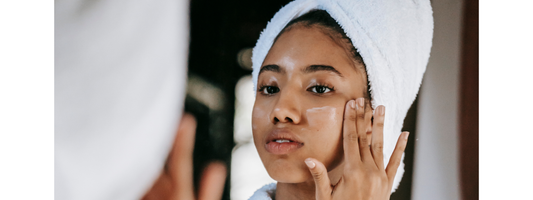 A woman applying skincare