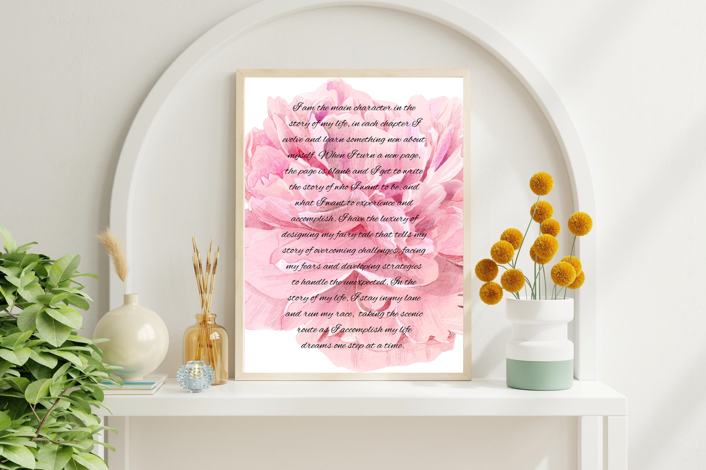 Framed printable poster with the phrase "Main Character Energy" in elegant script, placed on a white wall beside decorative vases. 