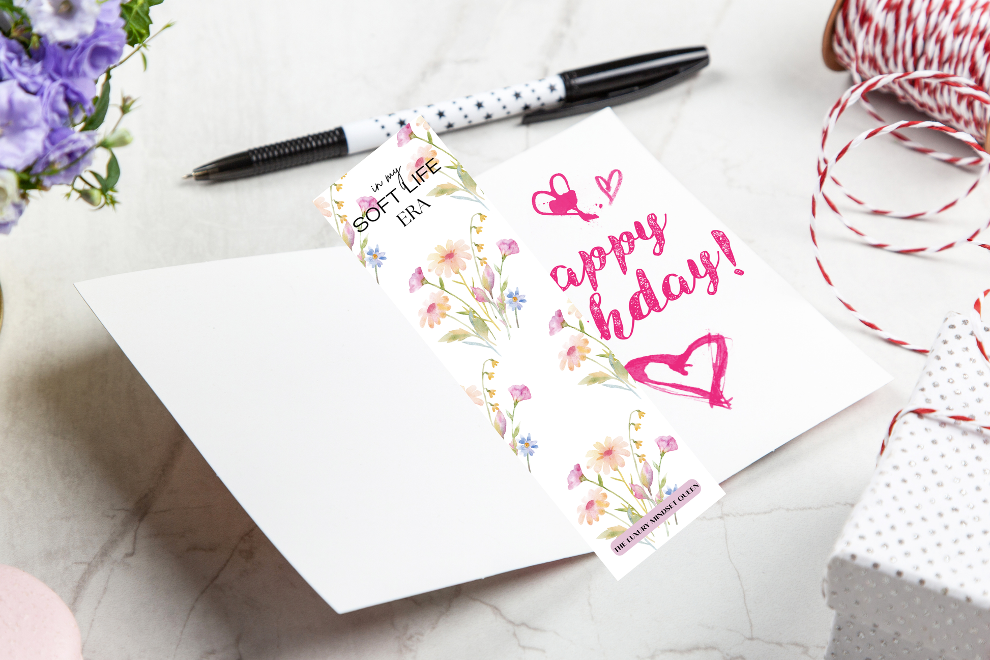 Elegant printable bookmark with soft floral design styled in an open Birthday Card.