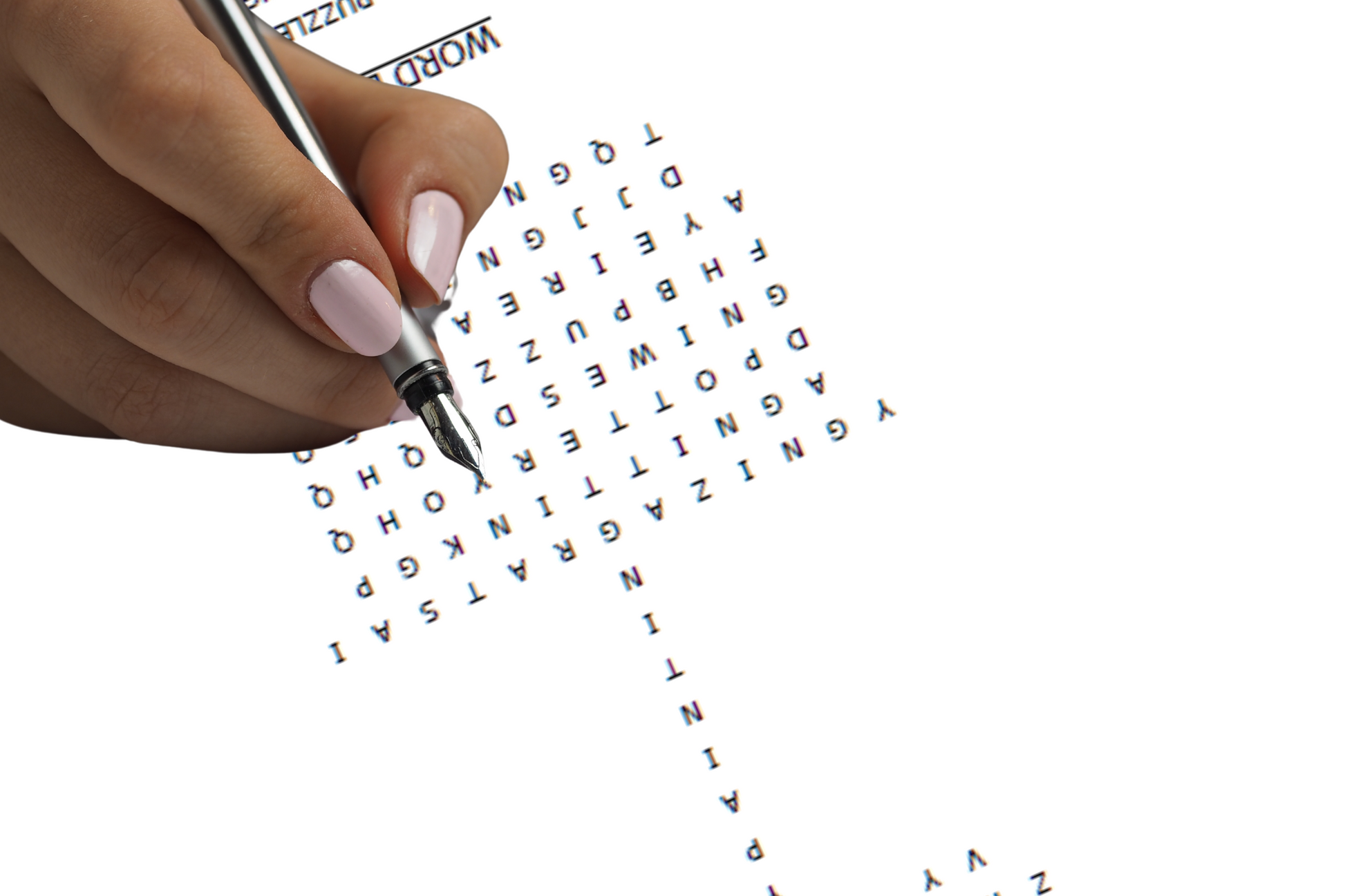 Hand holding a pen over a word search puzzle with letters scattered on a white background. Women's self-care hobbies puzzle.