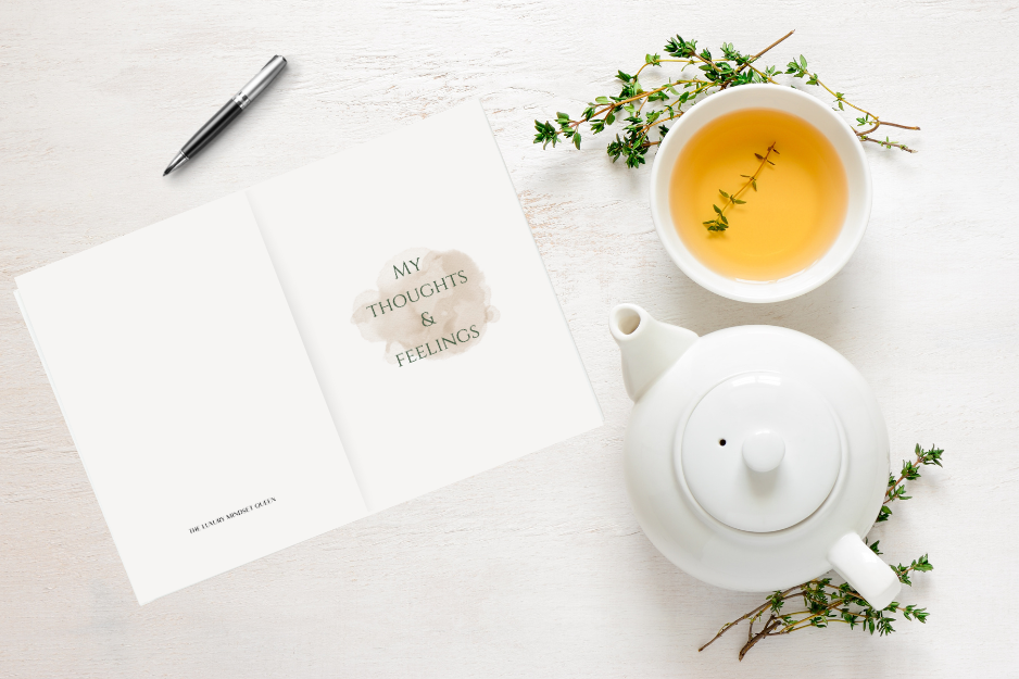 My Thoughts & Feelings journal on a wooden table beside a cup of herbal tea — a calming setup for soft life journaling, reflection, and self-care.

