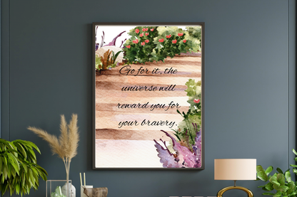 Printable wall art with the quote “Go for it, the universe will reward you for your bravery” over a watercolour garden path, framed and styled on a grey wall.