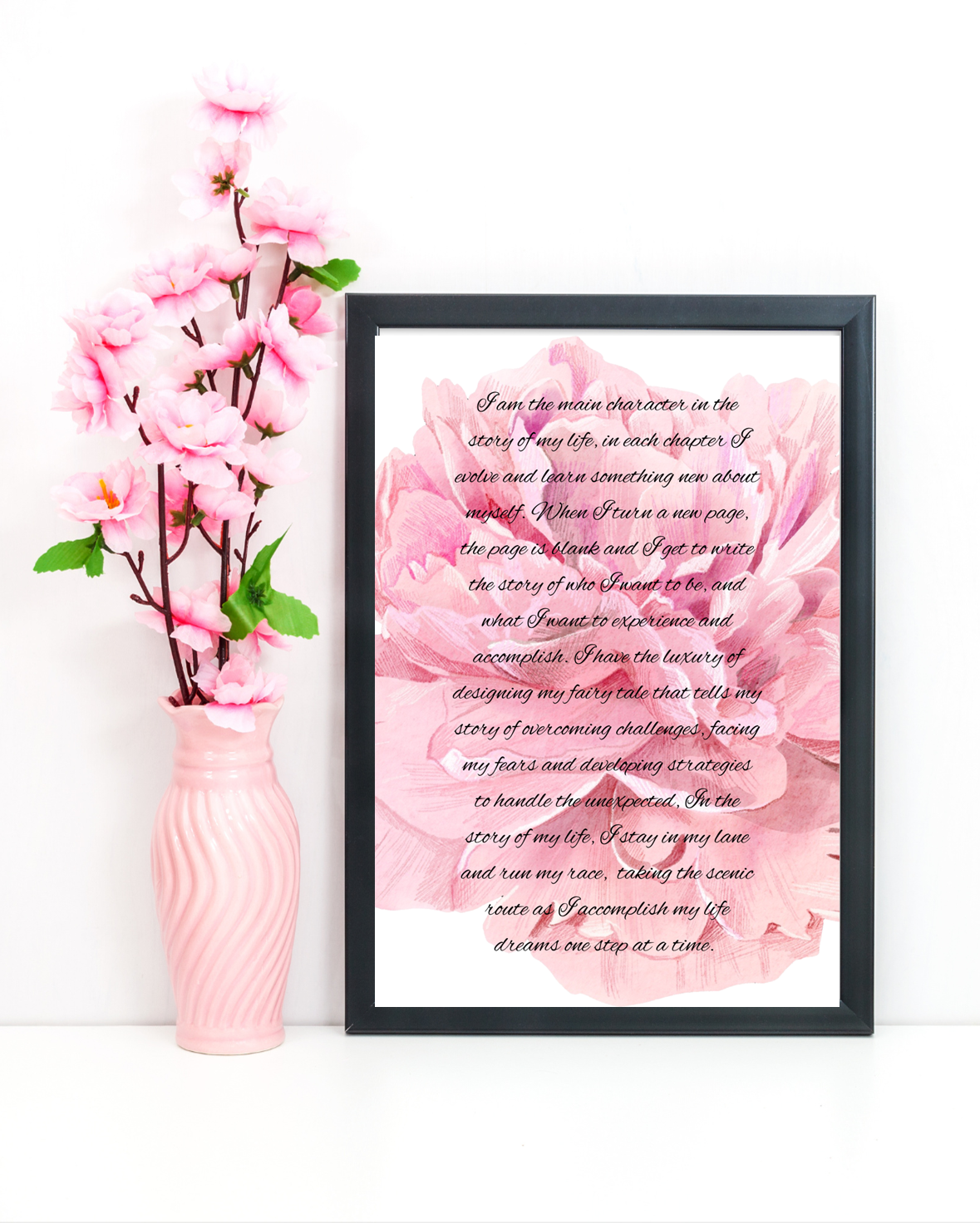 Close-up of motivational wall art with a soft pink floral background and bold black typography celebrating empowerment and self-love.