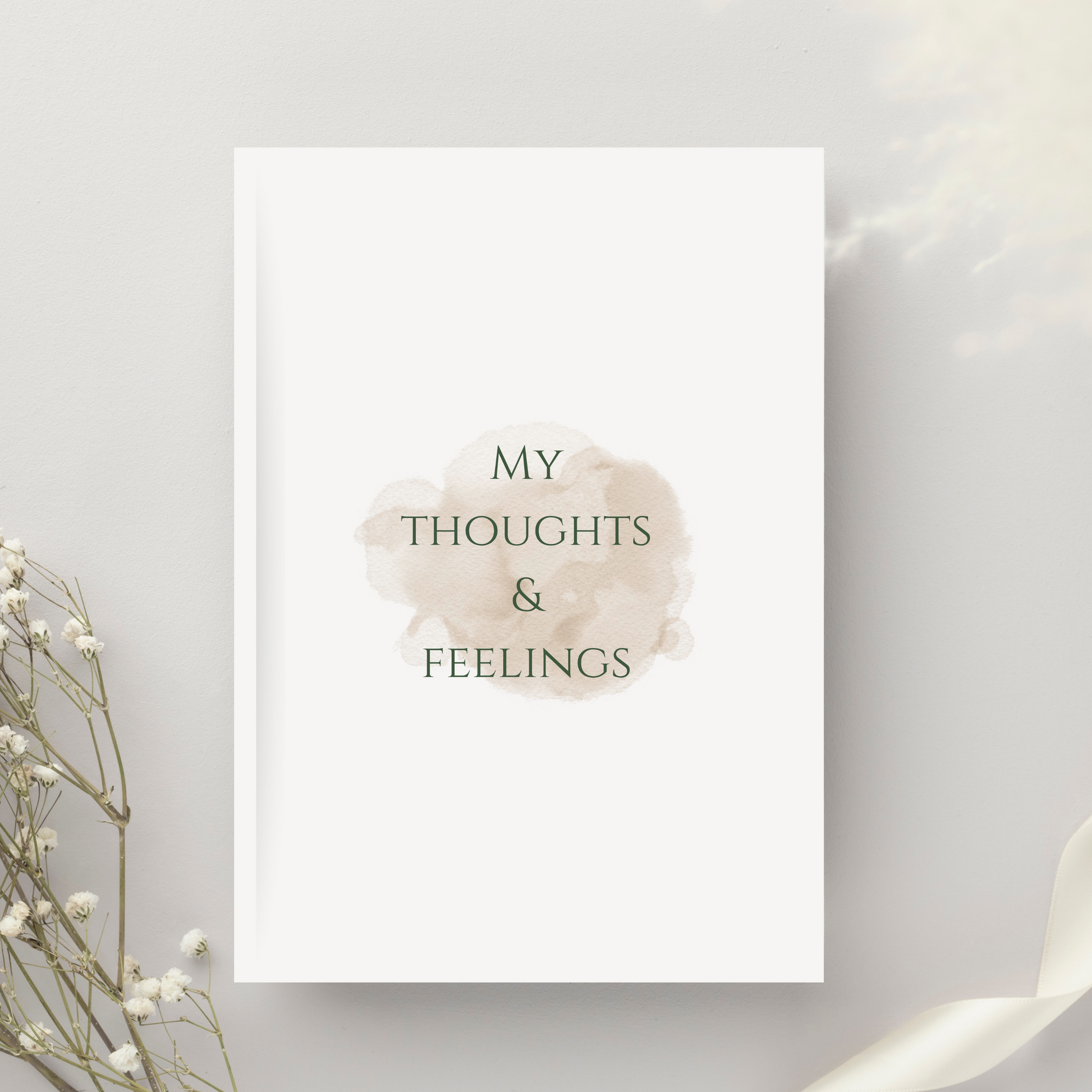 Feminine flat lay of My Thoughts & Feelings journal with soft life accessories, ideal for intentional journaling and daily self-care.

