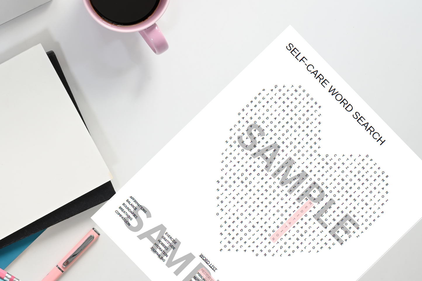 Sheet of paper with a self-care word search on a desk with a mug and notebook.