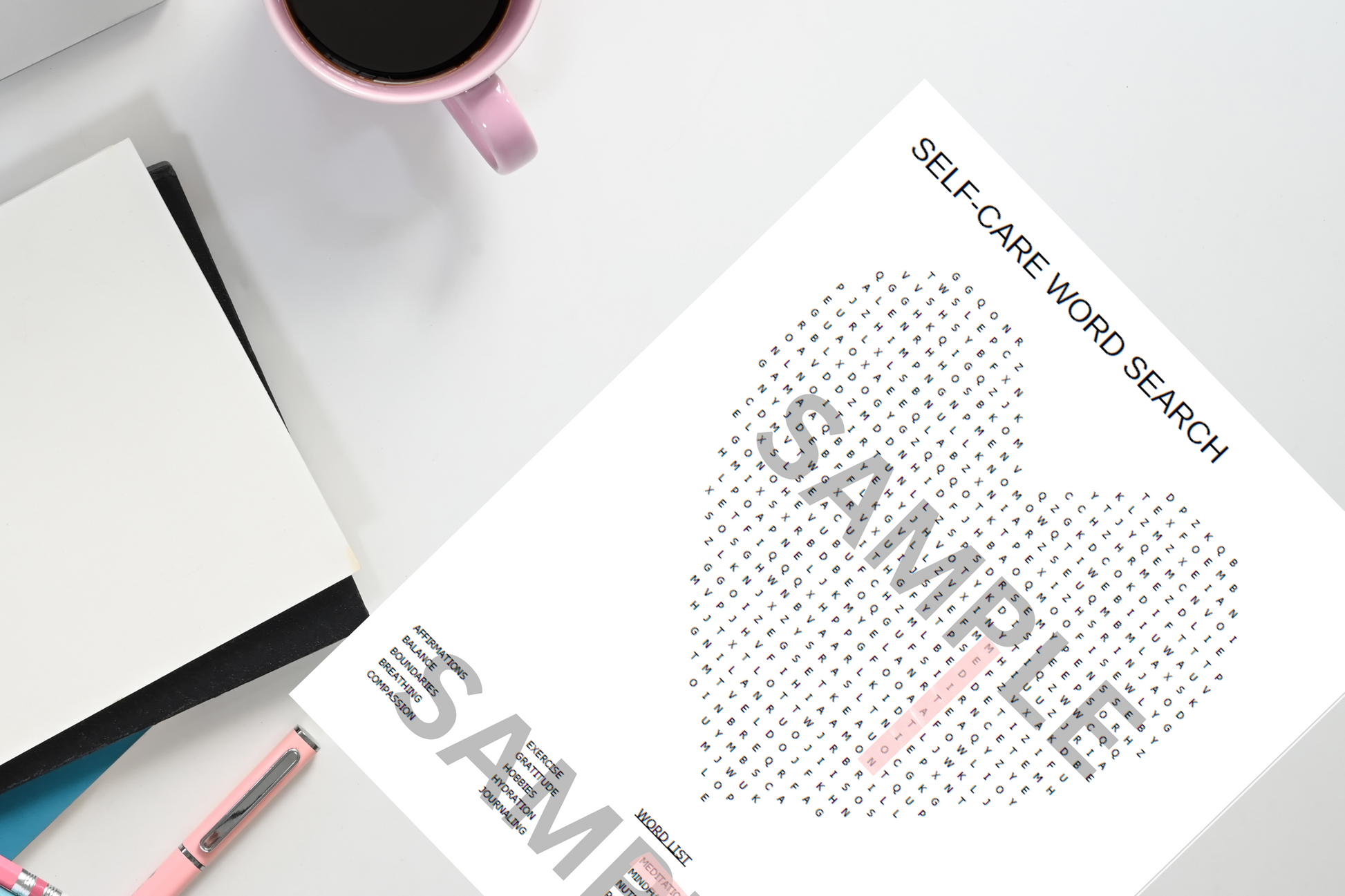 Sheet of paper with a self-care word search on a desk with a mug and notebook.