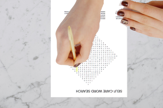A woman completing a self-care word search activity.