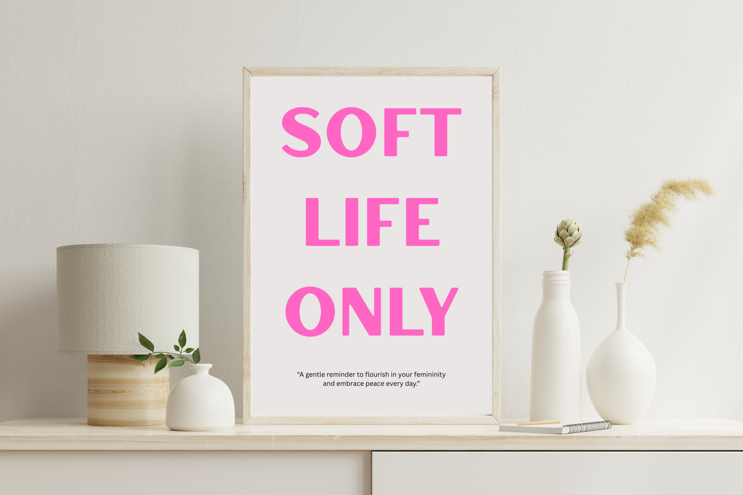 SOFT LIFE ONLY printable wall art poster with pink typography on grey background displayed in a modern living room