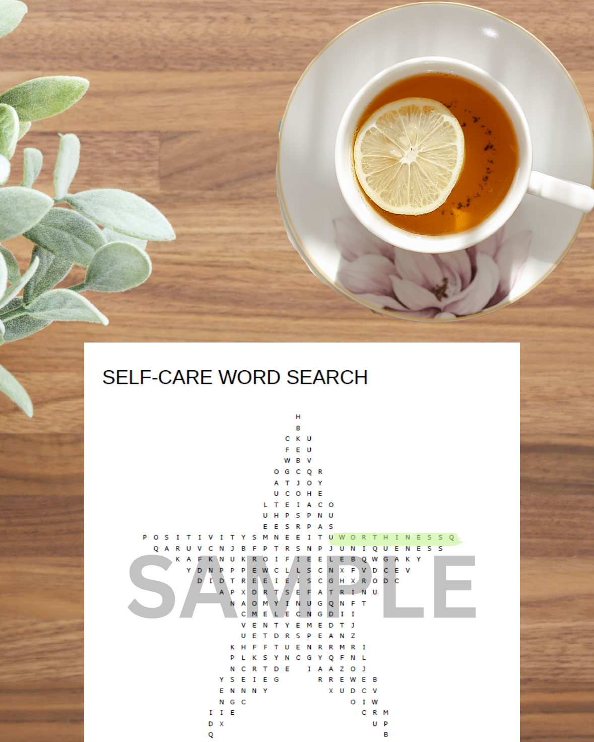 Empowering self-care word search activity displayed on a living room table with a plant and lemon tea