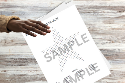 Woman's hand on a minimalist star-shaped word search on a wooden surface.